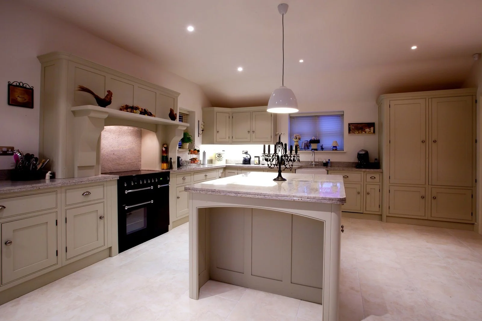 Classic painted kitchen with central island and range cooker