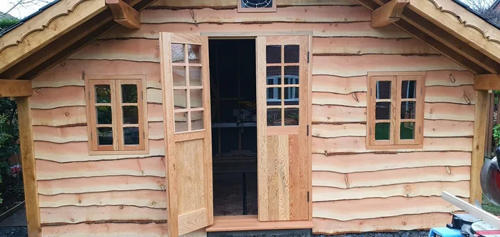 Handmade timber garden cabin with glazed double doors