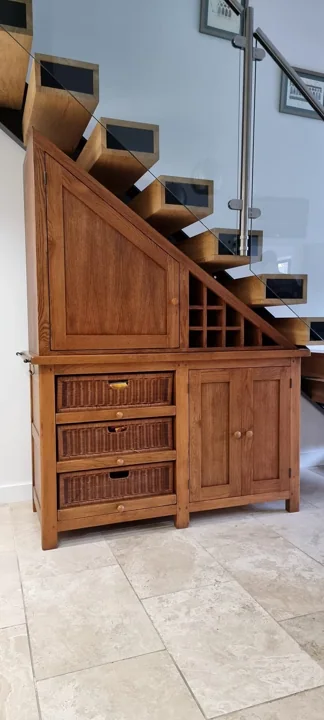Natural wood understair drawers and fitted cupboards